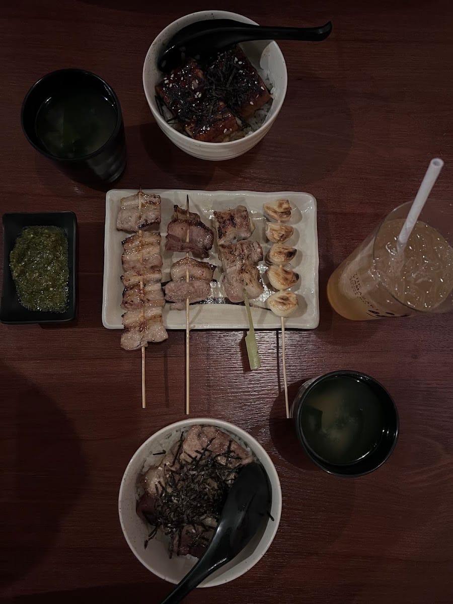 Grilled rice balls, sushi and skewers on a wooden tray at Mount Austin