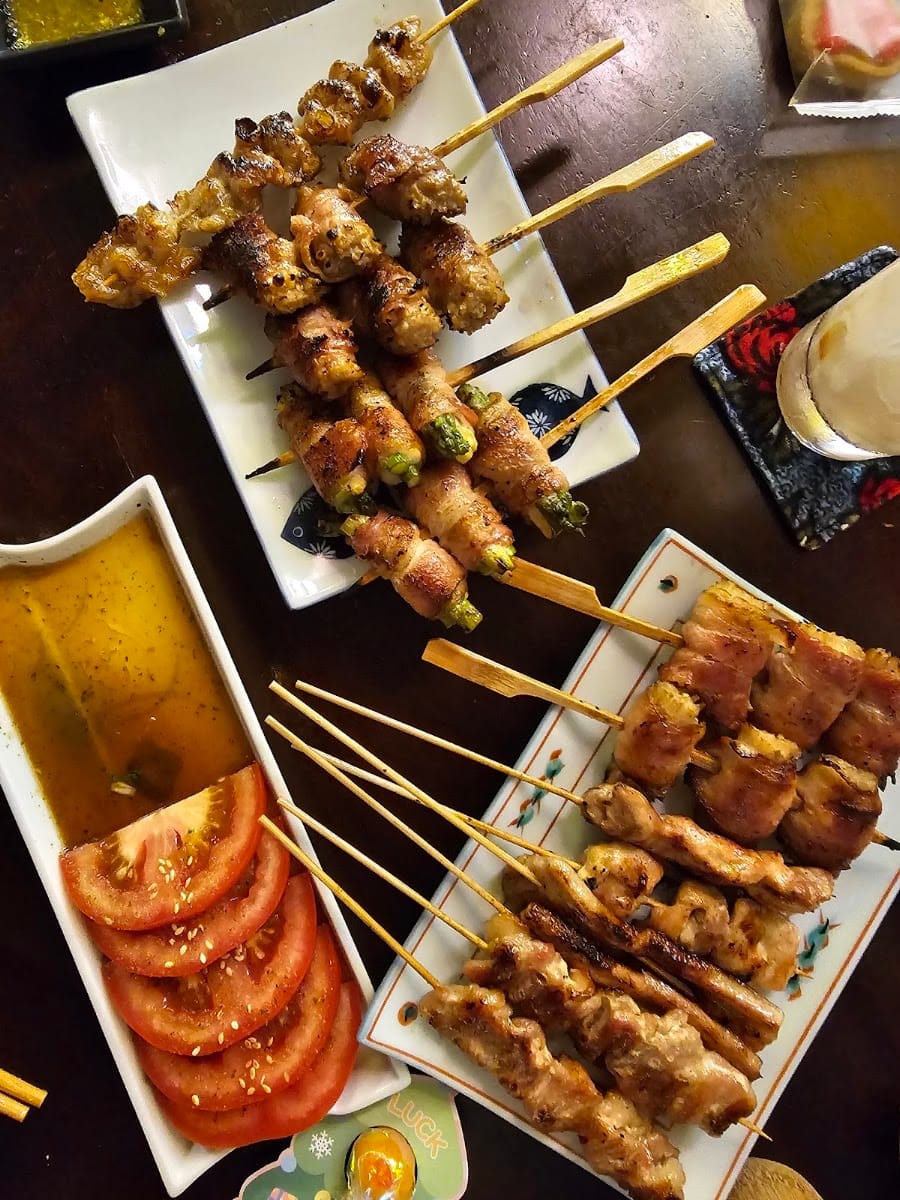 Assorted yakitori and bacon-wrapped asparagus skewers with tomato at Mount Austin